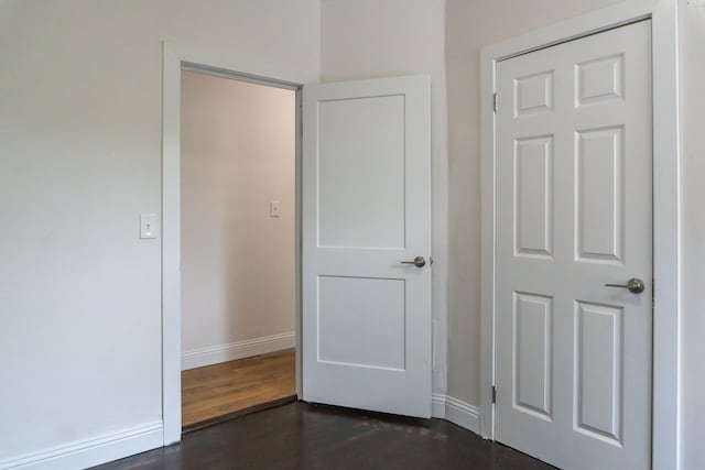 corridor featuring dark wood-type flooring