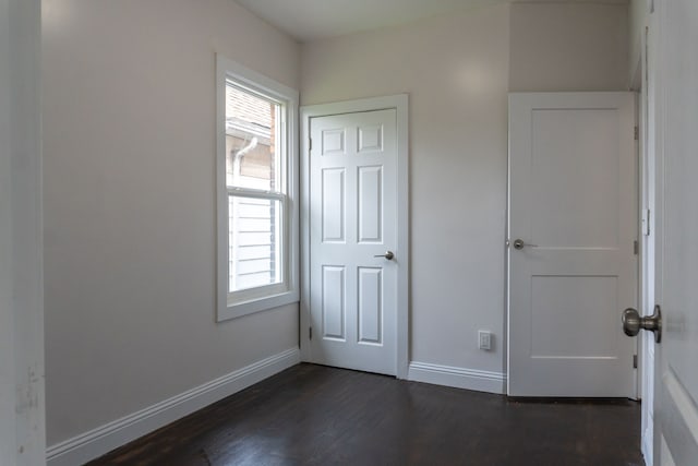 unfurnished bedroom featuring dark hardwood / wood-style flooring