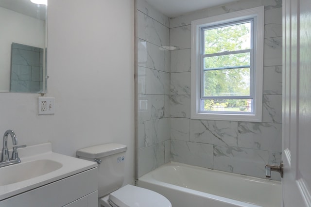 full bathroom with vanity, toilet, and tiled shower / bath