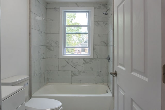 full bathroom with tiled shower / bath, vanity, and toilet