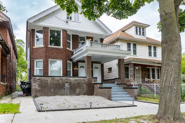 view of front of property featuring covered porch and a balcony