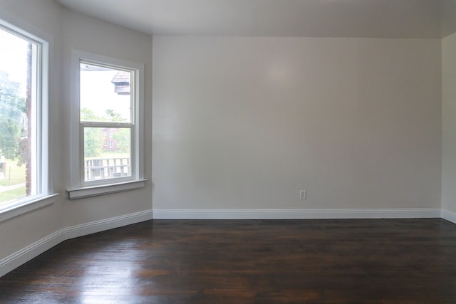 spare room with dark hardwood / wood-style floors