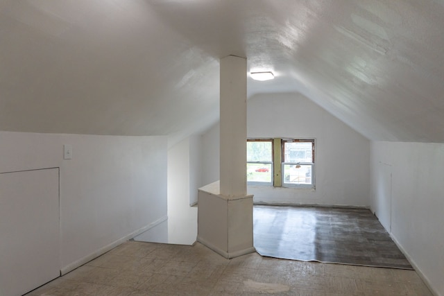 additional living space featuring vaulted ceiling