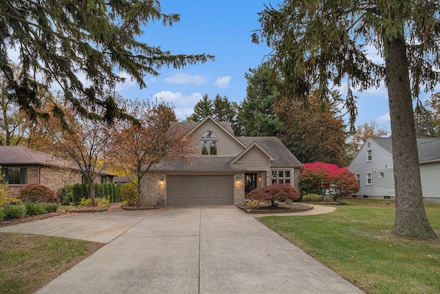 view of front of property with a garage and a front lawn