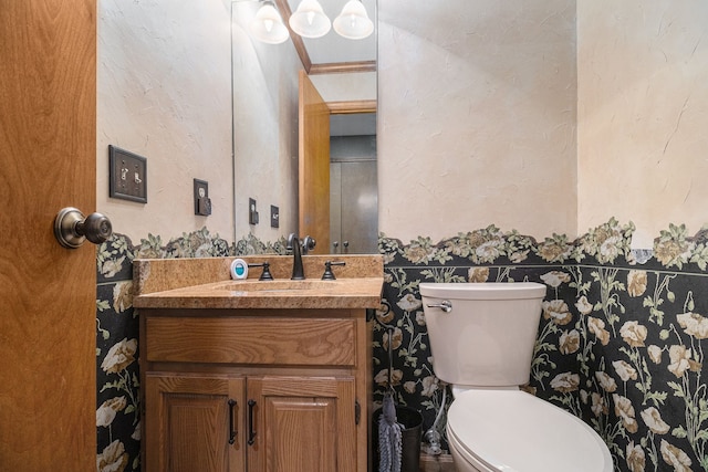 bathroom featuring crown molding, vanity, and toilet