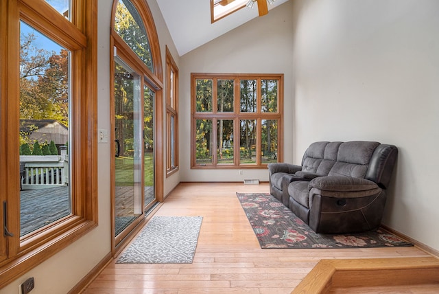 sunroom / solarium featuring plenty of natural light and vaulted ceiling with skylight