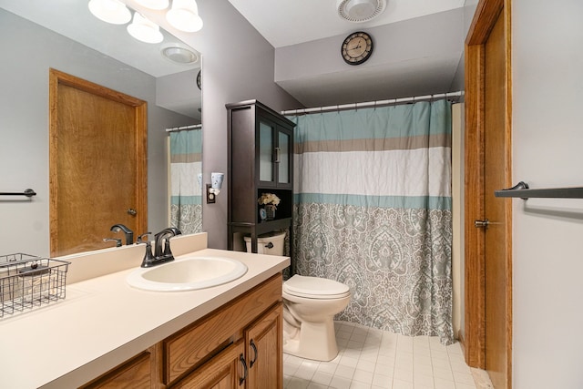 bathroom featuring tile patterned floors, vanity, and toilet