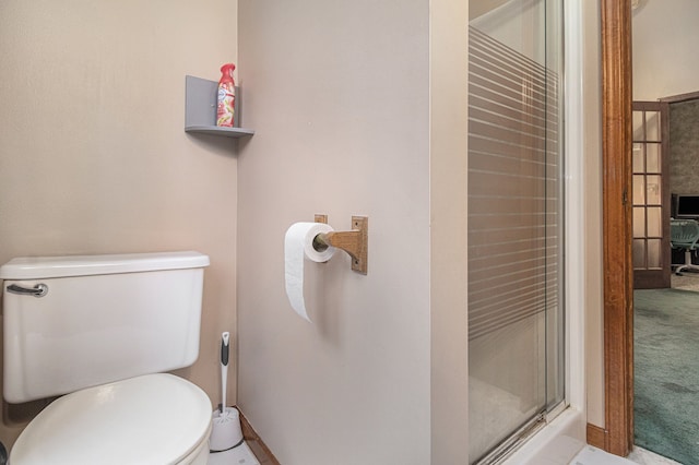 bathroom with toilet and walk in shower