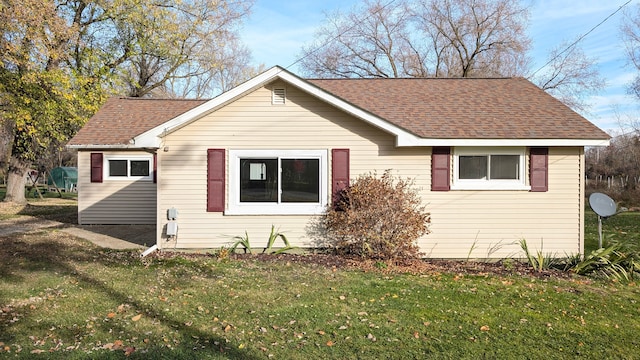 back of house with a lawn