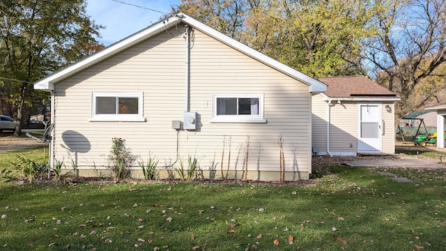 view of side of home with a yard