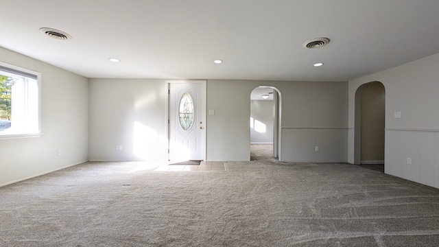 spare room featuring light carpet