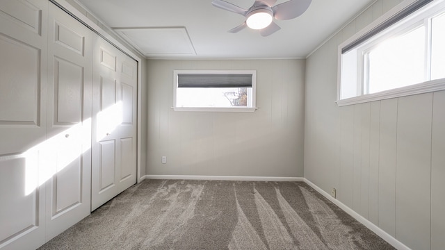 unfurnished bedroom featuring ceiling fan, crown molding, and carpet floors