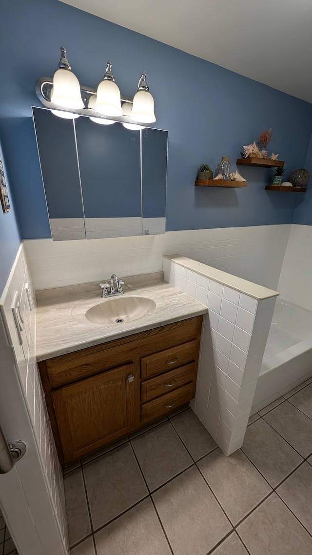 bathroom featuring tile patterned flooring, vanity, and tile walls