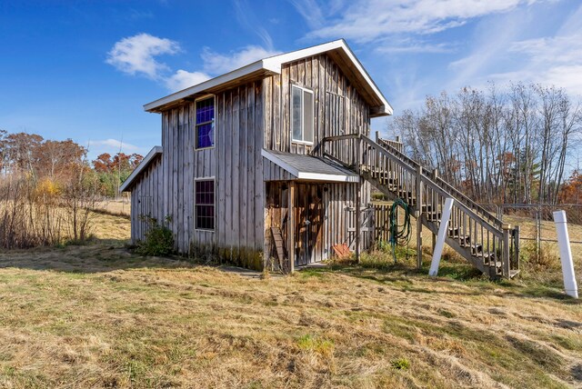 381 S Lorenz Rd, Tawas City, MI 48763 - back of property featuring board and batten siding and stairway