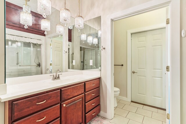 381 S Lorenz Rd, Tawas City, MI 48763 - bathroom with tile patterned floors, vanity, toilet, and baseboards