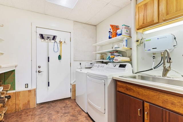 laundry room with cabinets, washer and clothes dryer, and sink