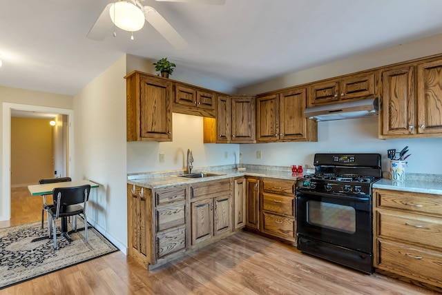 kitchen featuring ceiling fan, black range with gas stovetop, light wood-type flooring, and sink