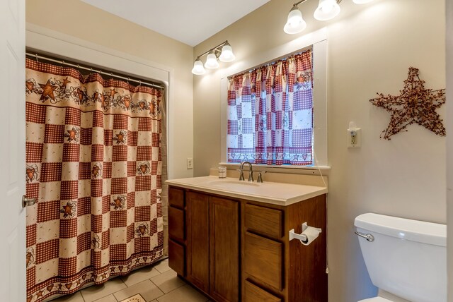 381 S Lorenz Rd, Tawas City, MI 48763 - bathroom with toilet, vanity, tile patterned floors, and a shower with curtain
