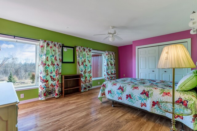381 S Lorenz Rd, Tawas City, MI 48763 - bedroom featuring wood finished floors, baseboards, ceiling fan, and a closet