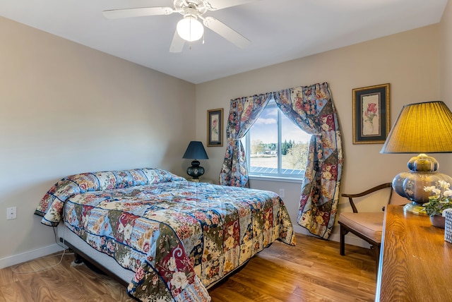 bedroom featuring hardwood / wood-style flooring and ceiling fan