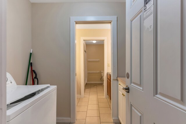 381 S Lorenz Rd, Tawas City, MI 48763 - laundry area featuring light tile patterned floors, baseboards, and washer and clothes dryer
