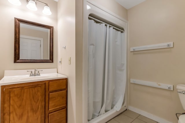 bathroom featuring curtained shower, tile patterned flooring, vanity, and toilet