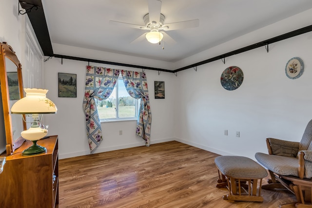 sitting room featuring ceiling fan and wood-type flooring