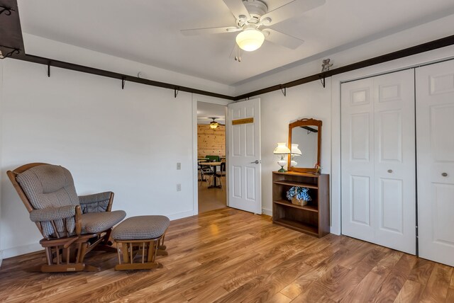 381 S Lorenz Rd, Tawas City, MI 48763 - sitting room with ceiling fan, wood finished floors, and baseboards