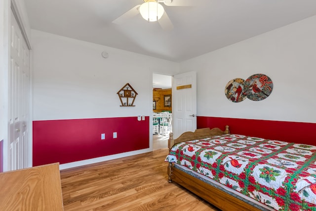 bedroom featuring hardwood / wood-style floors, ceiling fan, and a closet