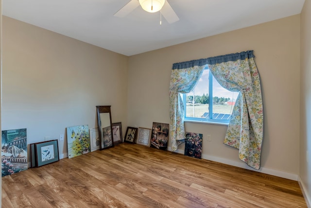 spare room with ceiling fan and wood-type flooring