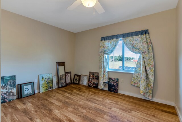 381 S Lorenz Rd, Tawas City, MI 48763 - unfurnished room featuring wood finished floors, ceiling fan, and baseboards