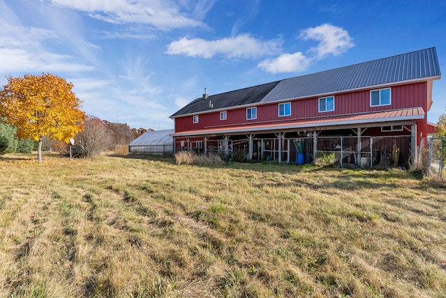 back of house featuring an outbuilding