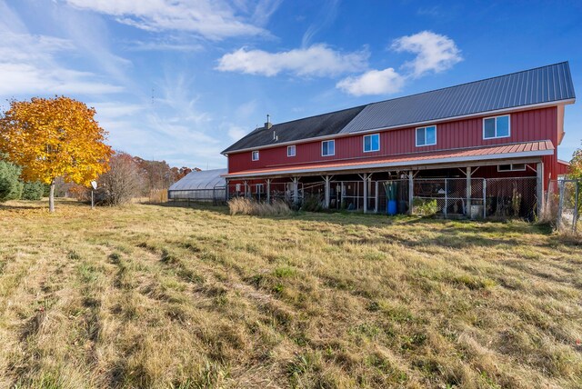 381 S Lorenz Rd, Tawas City, MI 48763 - rear view of property with metal roof, an outbuilding, and an exterior structure