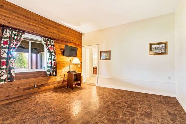 381 S Lorenz Rd, Tawas City, MI 48763 - unfurnished room featuring wood walls and baseboards