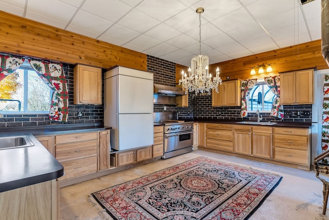 kitchen with backsplash, white fridge, pendant lighting, and high end stainless steel range oven