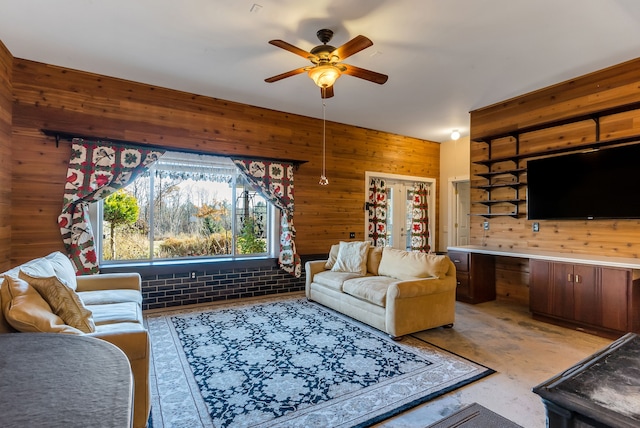 living room with ceiling fan and wooden walls