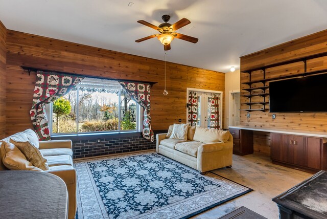 381 S Lorenz Rd, Tawas City, MI 48763 - living area featuring wooden walls and a ceiling fan