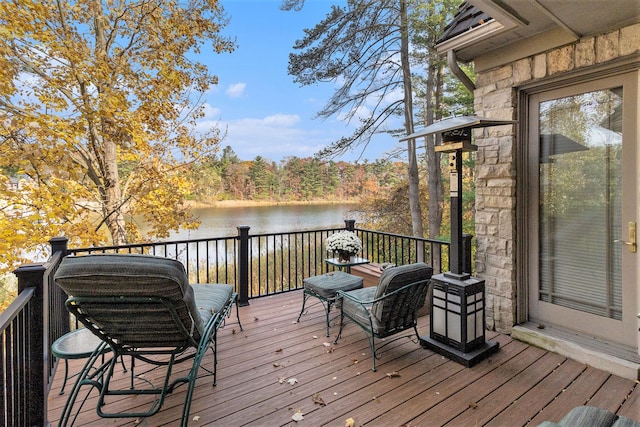 wooden terrace featuring a water view