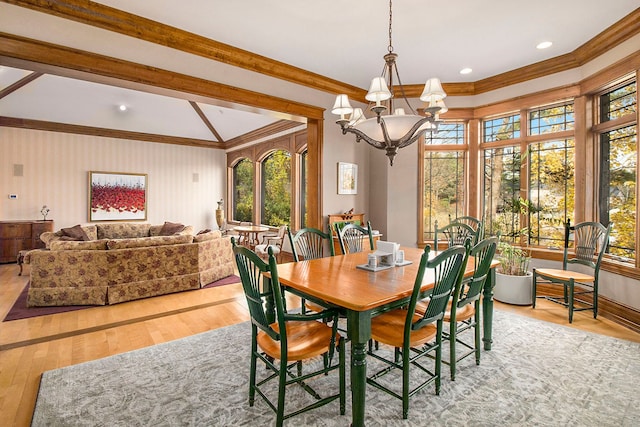 dining room with crown molding, light hardwood / wood-style flooring, and a chandelier