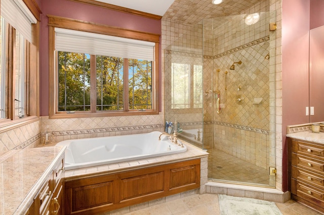 bathroom with plus walk in shower, vanity, and tile patterned flooring