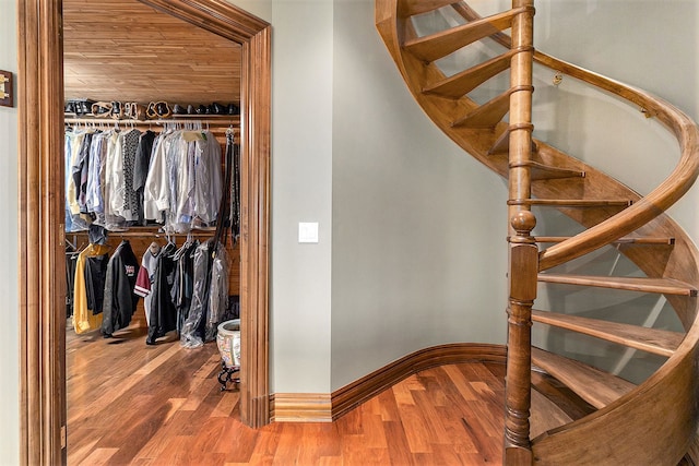 stairway featuring wood ceiling and hardwood / wood-style flooring