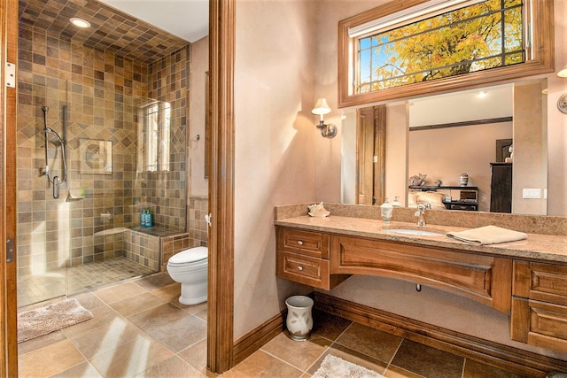 bathroom with tile patterned floors, vanity, toilet, and an enclosed shower