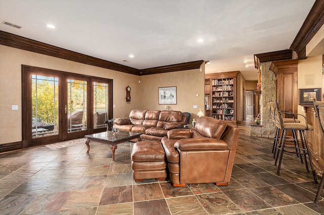 living room with built in features, ornamental molding, and french doors