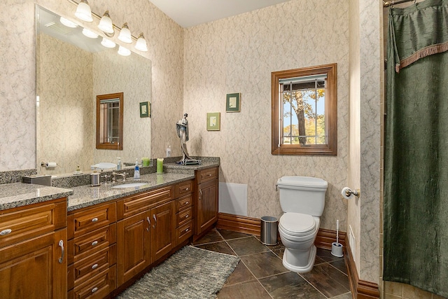 bathroom with tile patterned floors, vanity, and toilet