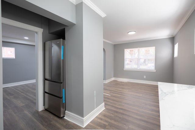 interior space with dark hardwood / wood-style floors and crown molding