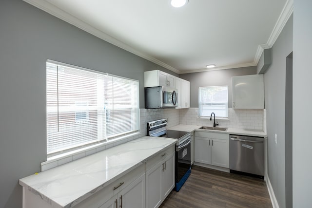 kitchen with white cabinets, dark wood-type flooring, and appliances with stainless steel finishes