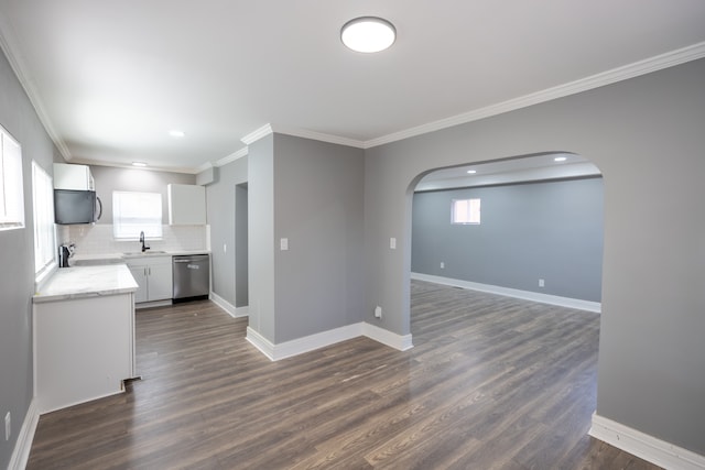 kitchen featuring a wealth of natural light, stainless steel dishwasher, and dark hardwood / wood-style floors