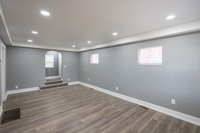 basement with dark hardwood / wood-style floors