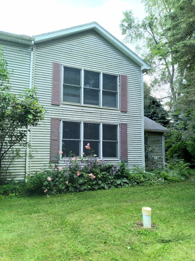 view of home's exterior with a lawn