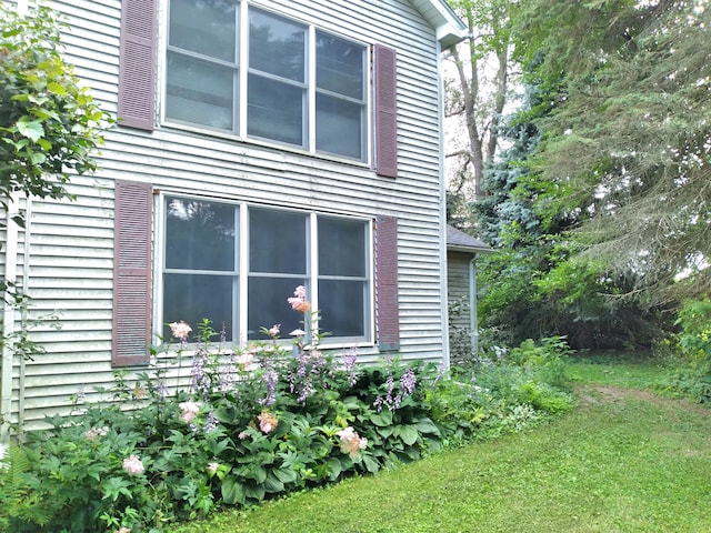 view of side of property with a lawn